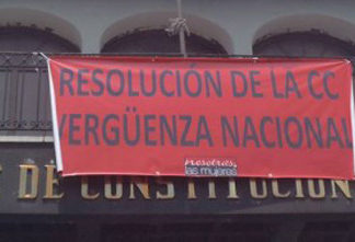 Main image: banner hung at the entrance of the Consitutional Court after it annulled the genocide verdict against Efraím Ríos Montt. Photo: Andrea Ixchíu