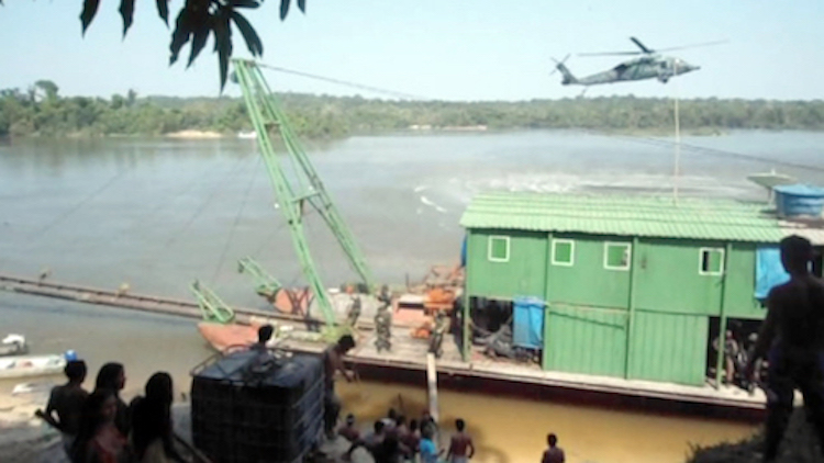 A police helicopter hovers during the Eldorado Operation above the gold mining barge before it was destroyed. This photo came from one of the only Munduruku cell phone cameras not destroyed by the Federal Police raiders. Photo: courtesy of Movimento Ipereg Ayu