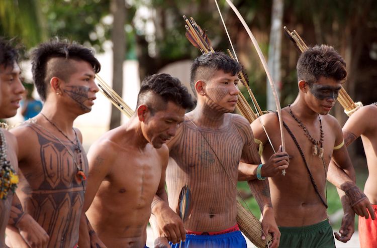Dancing Munduruku warriors, with ceremonial face paint used to welcome village visitors. This traditional face paint design was mistakenly perceived by the Federal Police as war paint. Photo: Mauricio Torres