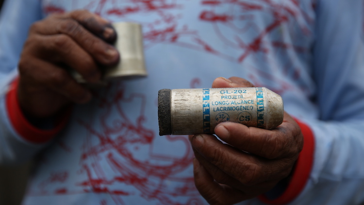 Indian showing a tear gas canister from the Federal Police raid. Photo: courtesy of Movimento Munduruku Ipereg Ayu