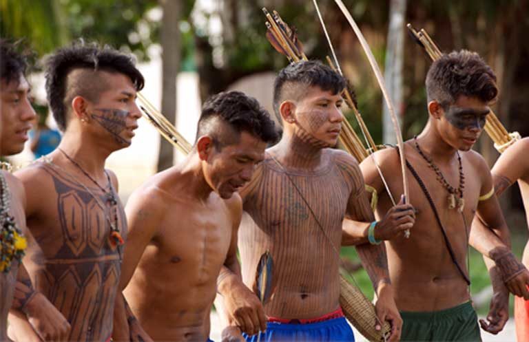 Dancing Munduruku warriors. The Munduruku have battled for years with the Brazilian government to get their lands formally demarcated, as have many other indigenous groups. Photo by Mauricio Torres