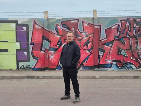Rodrigo Pino Vargas outside the perimeter wall of Sitio F, Arica, Chile. Credit- Matt Carr