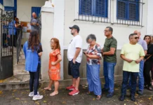 Brazil: Militias at the ballot box Voters queue beside the entrance to Escola Municipal Barão Homem de Mello in Rio de Janeiro, while an election worker directs people into the building.